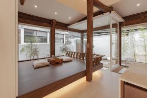 a room with two pillows on a wooden floor with windows at Jeonju Pungryu House in Jeonju