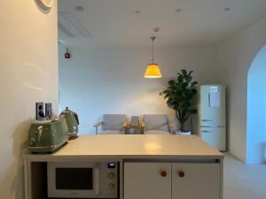 a kitchen with a microwave on top of a counter at Suncheon Stay Rev in Suncheon +13 photos