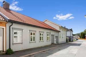 a row of small white buildings on a street at 2 bedroom appartment - walking distance to the Technology Park, City Center & Uni - Fully furnished in Kongsberg