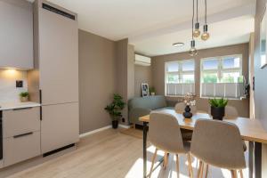 a kitchen and dining room with a table and chairs at 2 bedroom appartment - walking distance to the Technology Park, City Center & Uni - Fully furnished in Kongsberg