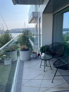 a balcony with a table and chairs on a building at Apartament Faltom 6 Yacht Park Premium in Gdynia