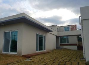 a large white house with at Jeju Bijarim Very Mung Pension in Jeju