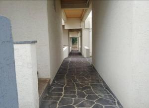 an empty hallway of a building with a stone floor at Jeju Bijarim Very Mung Pension in Jeju +5 photos