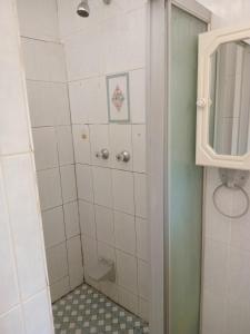 a bathroom with a shower with a toilet and a mirror at Whizzy lifestyle lodge in Duvhapark +22 photos