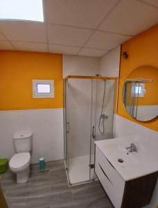 a bathroom with a shower and a toilet and a sink at Albergue Vía Vitae in Otur