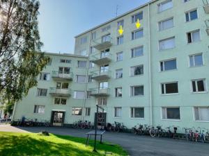 a large building with bikes parked outside of it at Kaupunkikoti Apartments 2-room B32 in Kemi