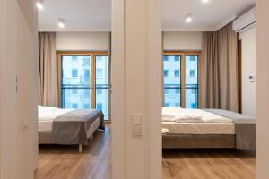 Posteľ alebo postele v izbe v ubytovaní Mennica Residence Luxury Location