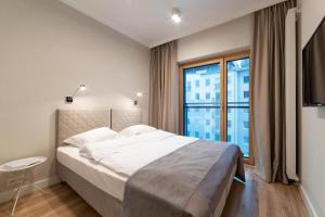 Posteľ alebo postele v izbe v ubytovaní Mennica Residence Luxury Location