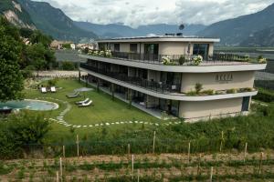 a large building with a garden and a resort at Belia Lofts - ADULTS ONLY - Apartments in Appiano sulla Strada del Vino
