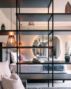 a black bunk bed in a living room at Belia Lofts - ADULTS ONLY - Apartments in Appiano sulla Strada del Vino