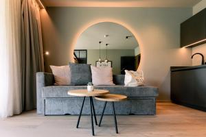 a living room with a couch and a table at Belia Lofts - ADULTS ONLY - Apartments in Appiano sulla Strada del Vino