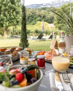 a table with food and drinks and a bowl of food at Belia Lofts - ADULTS ONLY - Apartments in Appiano sulla Strada del Vino