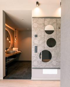 a bathroom with a sink and a mirror at Belia Lofts - ADULTS ONLY - Apartments in Appiano sulla Strada del Vino +37 photos