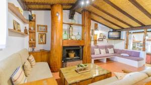 a living room with a couch and a fireplace at Grand Villa in Chimeneas, pool in Chimeneas