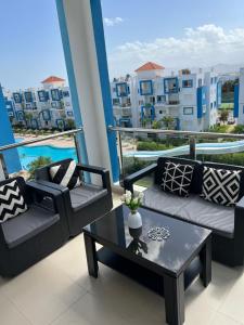 a balcony with two couches and a coffee table at Residence cabo negro in Cabo Negro