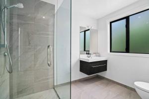a bathroom with a glass shower and a sink at Lake Living That Wanaka Tree in Wanaka +16 photos