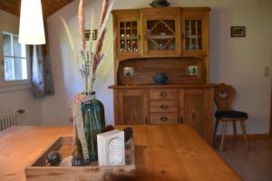 a vase sitting on a table in a kitchen at Berghof Almzeit - Fewo "Heuboden", Sauna , Todtnauberg, Feldberg in Todtnau