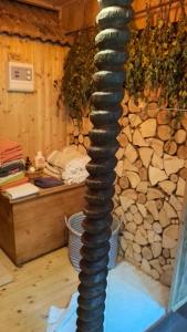 a large coil of rope in front of a stone wall at Ferienhof Ziegler Salbei in Baiersbronn
