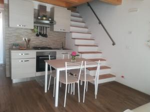 a kitchen with a table and chairs and a staircase at La casa di Alice in Venice