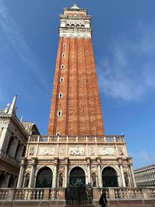 a tall clock tower in the middle of a building at La casa di Alice in Venice