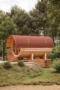 a wooden building with a roof on top of it at Gajówka Pilica 45A in Łęg Ręczyński +43 photos