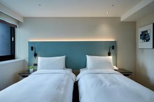Postel nebo postele na pokoji v ubytování K Hotel Taipei II + 37 fotografií