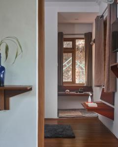 a door leading into a room with a window at Curly wood by Cluster cloud in Thekkady