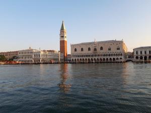 a view of a city with a clock tower and water at La casa di Alice in Venice