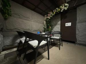 a table and chairs in a restaurant with flowers at Rosenheim Tokyo Shinjuku in Tokyo