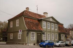 a house with a blue car parked in front of it at Goldingen in Kuldīga