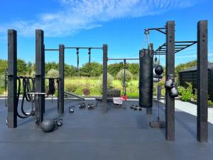 a gym with swings and other equipment at Thistledown Lodge in Fethard on Sea