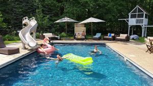 a group of children playing in a swimming pool at Ruffino Retreat in Union Pier