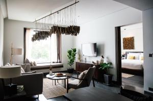 a living room with a bed and a room with a couch at Treeline Urban Resort in Siem Reap +81 photos