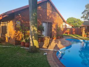 a house with a swimming pool next to a building at Cassiandra Place unit 2 in Richards Bay