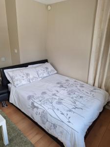a small bedroom with a bed with a white blanket at Independent Studio Apartment in Wicklow