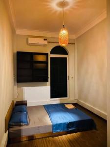 a bedroom with a bed in a room with a window at Homestay May's house Lo Duc in Hanoi