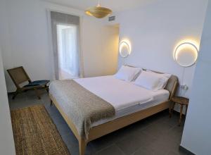 a bedroom with a bed and a chair at Sea&Ski Oasis Apartment in Salobreña