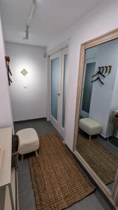 a hallway with a large mirror and two chairs at Sea&Ski Oasis Apartment in Salobreña