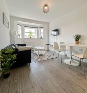 a living room with a couch and a table at Wellington Road Apartment 5 in Southtown