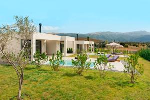a villa with a swimming pool and a garden at Ioannina Secret Luxury Villas in Ioannina