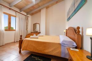 a bedroom with a bed and a table and a mirror at Gina in Algaida +39 photos