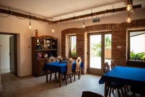 a dining room with blue tables and chairs at Tokaji Dűlő Vendégház in Tokaj