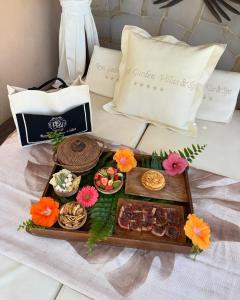 a tray of food on a table with flowers at Royal Garden Villas, Luxury Hotel in Adeje
