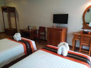 Postel nebo postele na pokoji v ubytování Princess River Kwai Hotel