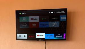a flat screen tv hanging on a wall at Enchanting Oasis in Embu