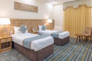 Ένα ή περισσότερα κρεβάτια σε δωμάτιο στο Snood Al Dana Hotel