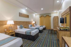 Ένα ή περισσότερα κρεβάτια σε δωμάτιο στο Snood Al Dana Hotel