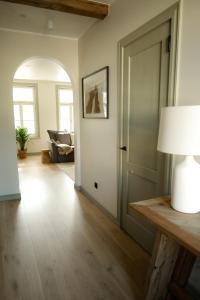 a living room with a white door and a lamp at Vaksali Apartment, kaks minutit Ugalast in Viljandi