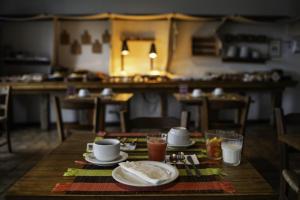 a wooden table with a plate of food and drinks at Bahiacafé Hotel in Salvador