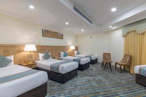 Ένα ή περισσότερα κρεβάτια σε δωμάτιο στο Snood Al Dana Hotel